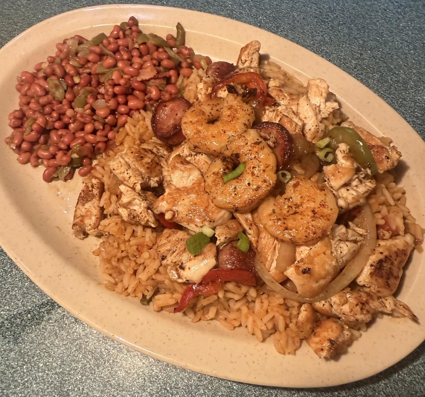Grilled chicken and shrimp with andouille over cajun rice, with a side of red beans